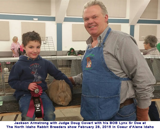 Jackson Armstrong with JUDGE Doug Covert with his BOB Lynx Sr Doe at The North Idaho Rabbit Breeders show February 28th in Coeur d'Alene Idaho 